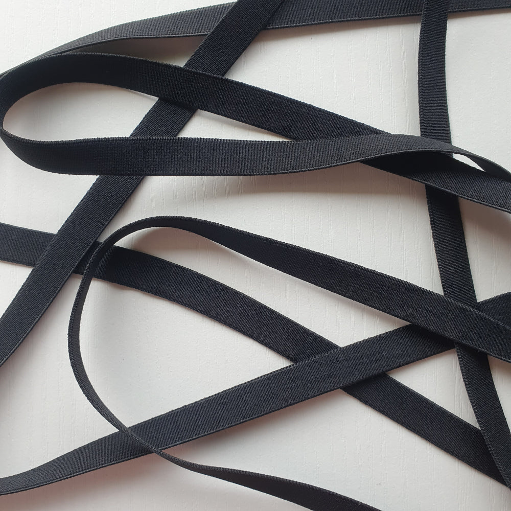 Black 12mm high density non-roll elastic arranged on a plain white background.