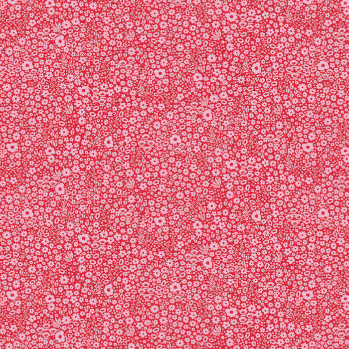 A close-up of a repeating floral pattern in coral red and white, showing small daisy-like blossoms and leaves filling the frame.