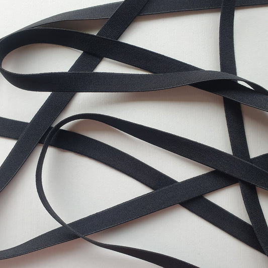 Black 12mm high density non-roll elastic arranged on a plain white background.