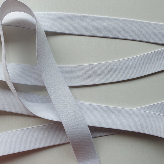 White 25mm high density non-roll elastic arranged on a plain white background.